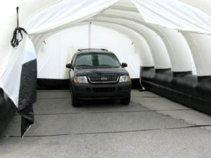 Grab a big canvas duffle bag and a blower and , in minutes an inflatable Fast Shelter protects workers and vehicules from the elements. Photo: Sky Signs Balloons Ltd.