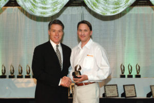 Rowley CEO Bill Taylor accepts the WOW! award for outstanding customer service.