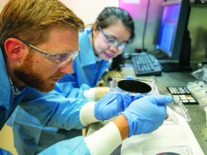 Researchers Eric Meshot, left, and Ngoc Bui evaluate the uniformity of a carbon nanotube array covering the entire area of a 4-inch wafer. Photo: Julie Russell/LLNL.
