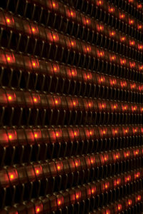 Visual effects for metal mesh: In addition to washing etched metal fabric facades with dramatic exterior lighting as it did with the New World of Coca-Cola museum project, Cambridge Architectural recently annouced its integrated LED lighting and graphic effects technology as part of its MESH?FX line of visual enhancements for metal facades. LED lighting can be used to create dynamic visual effects on all types of metal-clad facades. Lightweight metal mesh fabric is a good choice for incorporating LEDs vecause the mesh helps hold the strips of lights in place without obstructing their glow. Photo: Cambridge Architectural.