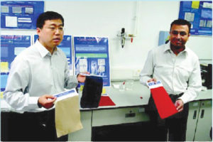 Professors Xin and Daoud hold patents on self-cleaning technologies using nanocrystals that break down wine stains in sunlight. Photos: Hong Kong Polytechnic University.