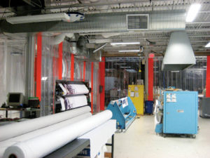 Portland Color made many green changes to its facilities, including the fabric print room. The room has an extra-large vent on both the printer and the heat transfer equipment. The disk on the ceiling behind the light is part of the humidification system the company installed to maintain even humidity year round. Photo: Portland Color.