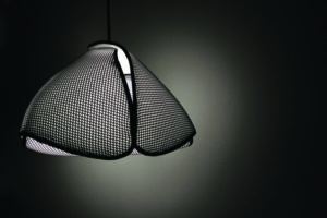 Stolarski’s other lamp designs use aluminum, steel and wood to achieve more angular effects. The Loop’s 3-D fabric mesh and the nylon threads inside the lamp diffuse light for a gentle atmosphere. Photo: Catherine Stolarski