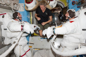 NASA astronaut Chris Cassidy (left) and European Space Agency astronaut Luca Parmitano, attired in their Extravehicular Mobility Unit (EMU) spacesuits, participated in a “dry run” in the International Space Station’s Quest airlock to prepare for spacewalks in 2013. NASA astronaut Karen Nyberg, flight engineer, assists. Photo: NASA