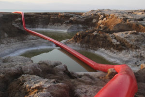 The Red Line Project involves the installation of one or multiple tubes, in red or other colors, to illustrate the impacts of climate change and environmental deterioration at the site of some of the world’s most threatened natural resources. Photo: Doron Gazit