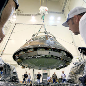 Inside the Launch Abort System Facility at NASA’s Kennedy Space Center in Florida, workers prepared the Orion spacecraft that flew on Exploration Flight Test-1 in 2014 for transport to Orion prime contractor Lockheed Martin's facility in Denver, where it would undergo direct field acoustic testing. Photo: NASA/Kennedy