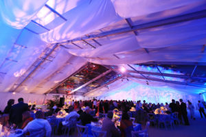 All Occasions Event Rental provided 13,550 square feet of structure for a wedding in Cincinnati, Ohio. The ceremony and reception were housed under an 82 x 165-foot clearspan tent that was separated by an interior gable draped with custom panels. The ceremony area featured an open gable that looked out over a hillside, while the reception area included two clear panels to create a skylight over the dance floor. Photo: All Occasions Event Rental. 