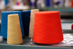 Shown: inventoried yarns to be readied for knitting mills. Minnesota Knitting Mills has more than 200 knitting machines and offers knit applications for apparel, non-apparel and medical items, such as brand-name coats, custom braid for professional sports, knitted filters used in blood transfusions and other products. Photo: Minnesota Knitting Mills Inc.