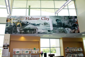 The history of Haltom City is told visually on a stunning mural that hangs in the community library. Photo: The Bubble™.