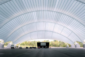 Six fabric panels are supported by seven steel trusses, which are supported by 18 concrete piers—each of which is 30 percent underground—weighing a total of 7,000 tons and containing more than 39 miles of steel reinforcement bars. Photo: IIHS.