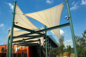 Shade structures outside the San Antonio, Texas, DoSeum—a museum “where children learn by doing”—contribute to the museum’s sustainable focus. The building is slated to receive LEED Gold certification, and the fabric shade elements in the outdoor exhibit areas, interlaced with water features, help provide a climate-friendly space for children to learn. The Chism Company used shade fabric tensioned between powder-coat painted steel masts and attached to welded steel rings at the top of the masts. A combination of galvanized and powder-coated fittings includes clevis ends with shackles on two points and a turnbuckle on the third point of each shade. Photo: The Chism Company.