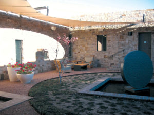 At this private residence in Tesueche, N.M., the tensioning cable terminates in Ronstan stainless jaw attached to steel plate. The plate is tied back to the masonry wall with stainless Ronstan turnbuckles. Photo: Craig Huntington.
