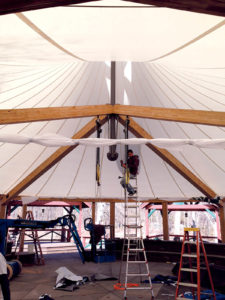 Installing a cone-shaped fabric roof involves using chain hoists (center), to jack up the center point mast and properly tension the fabric. Photos: Samuel Armijos, Fabric Architect LLC.