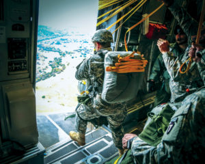 A Soldier from the 1st Battalion, 143rd Infantry Regiment (Airborne) takes his last steps out the door during a training jump on Nov. 14, 2014. The battalion departed Austin’s Bergstrom International Airport on two Altus Air Force Based C-17s, flew to Fort Hood, and then jumped into the Rapido Drop Zone wearing full combat gear. The 1-143rd is from the 36th Infantry Division (Texas Army National Guard) (U.S. Army National Guard photo by Maj. Randall Stillinger)