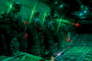 Survival, evasion, resistance and escape specialists wait before performing static line jumps as the door of a C-130 Hercules, assigned to Dobbins Air Reserve Base, Ga., opens over the Nevada Test and Training Range, Nev., March 11, 2016. SERE specialists lead the Air Force emergency parachuting program and conduct extensive testing of parachuting systems. They are uniquely suited to analyze the operating environment to plan for evasion, captivity and recovery considerations. Photo: U.S. Air Force photo/Airman 1st Class Kevin Tanenbaum.