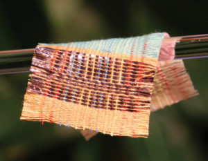 Woven fabric includes strands of material that can generate electricity from two sources: sunshine and movement. Photo: Georgia Institute of Technology.