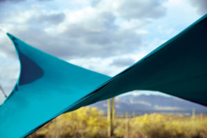 On arid landscapes, where both shade and wind protection are necessary, one architectural solution that enlivens the scene is woven mesh, solution-dyed acrylic, such as this Sunbrella® shade structure. Photo: Glen Raven.