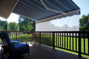 Retractable awnings from Eclipse Shading Systems® can be accessorized with a shade that drops from the front end to protect outdoor areas from low sun and add privacy. Photo: Eclipse Shading Systems. 