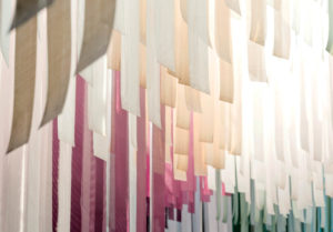 Fabric installation adds warm, colorful hues to a contemporary café. Photos: DEFERRARI+MODESTI. 