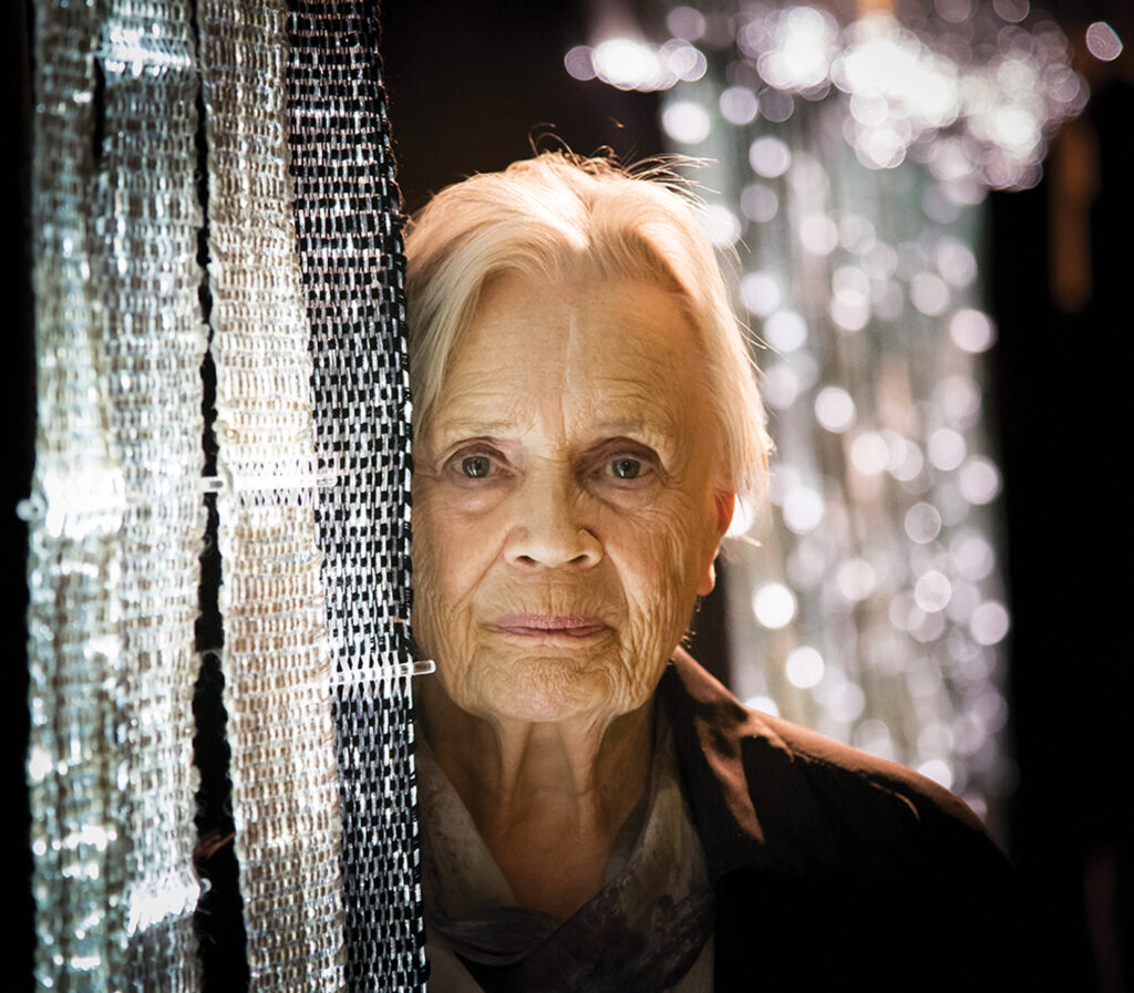 Finnish textile artist Maija Lavonen in 2012 next to her art piece Surface of Light. 