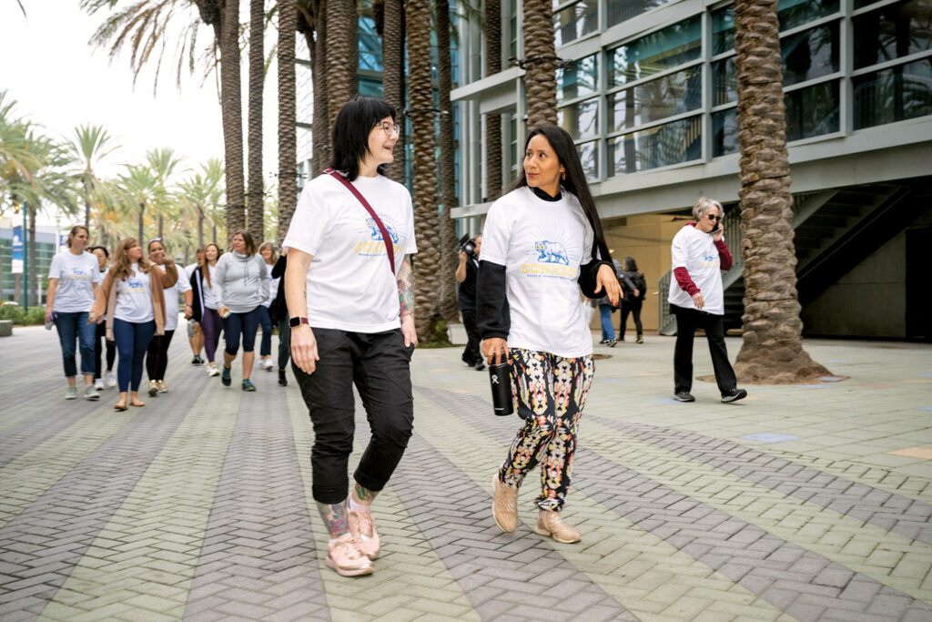 A women's networking walk is a recurring morning event at Advanced Textiles Expo. Pictured are groups of women walking and talking.