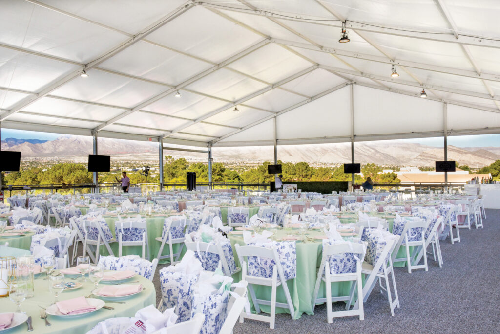Inside of an A-frame tent that included chairs and tables.