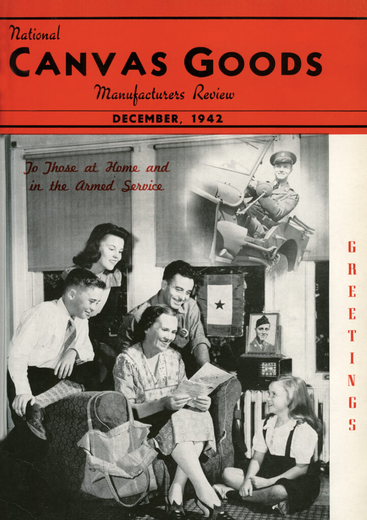 The December 1942 of the National Canvas Goods Manufacturers Review has a black-and-white picture of a family gathered in a living room to hear a letter read from their serviceman. Behind them in the window is a textile with a blue star on it, signifying that he is overseas but alive. A framed picture of him is on top of the radio.
The soldier is pictured in  a circle at the upper right of the image of the family. He is sitting in a Jeep. 
