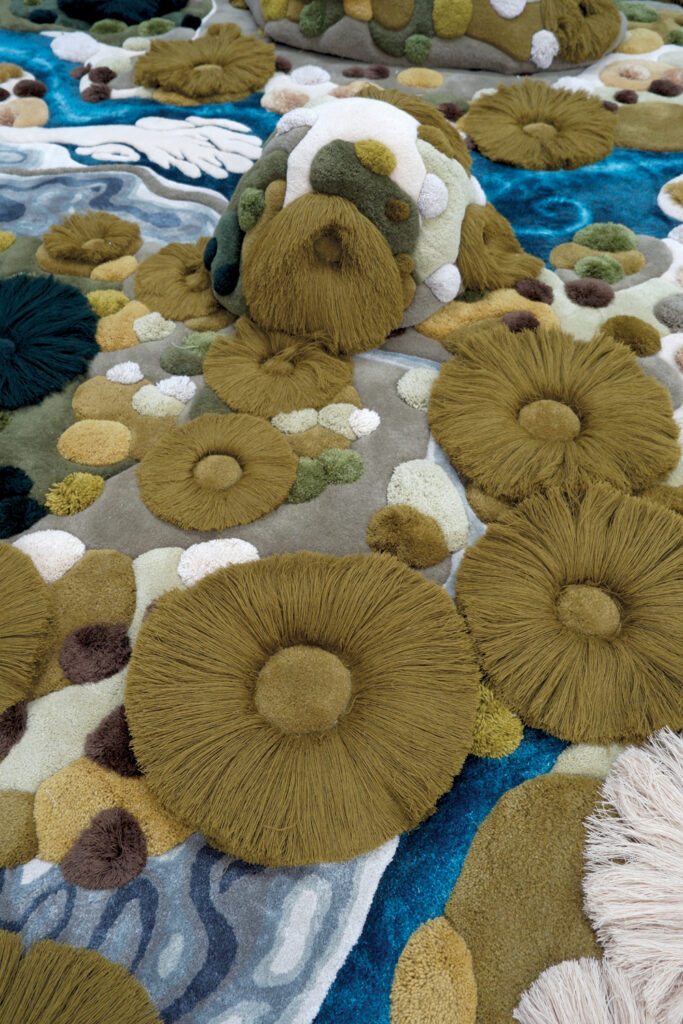 Green, blue and gray tufts on a rug.
