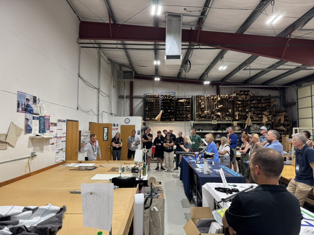 Steven Wayne shows a demonstration to a standing crowd of fabricators.