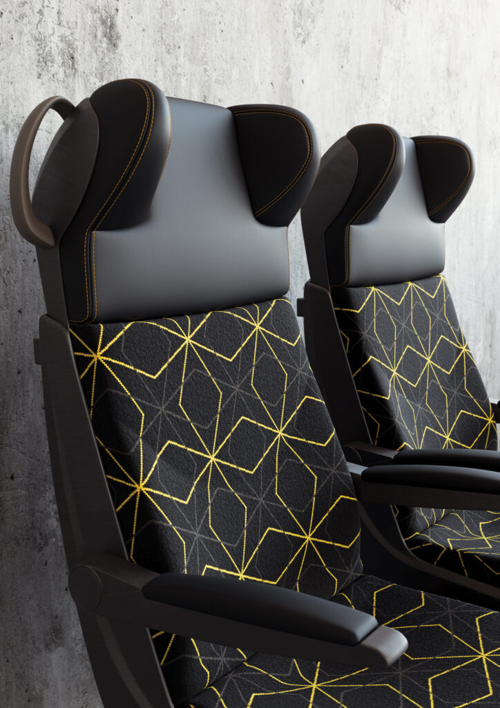 Two seats with hexagonal yellow and gray patterns on black fabric, set against a textured gray wall.