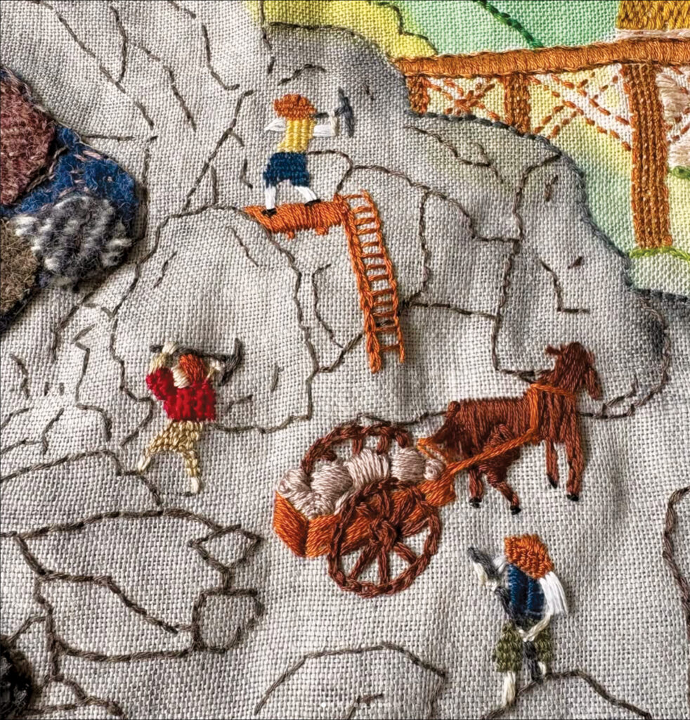 Embroidered scene depicting workers mining rocks, a horse-drawn cart, and a ladder, set against a colorful background.