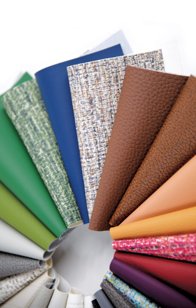 A circular arrangement of various textured fabric samples from Ennis Fabrics' Guardian Collection in vibrant colors, including greens, blues, browns, and oranges, on a white background.