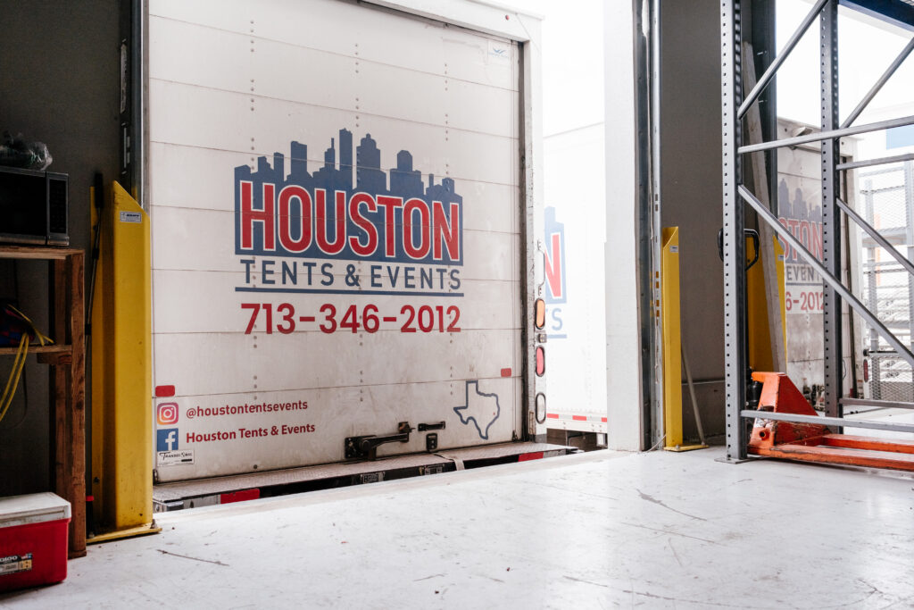 HTE The rear of a delivery truck featuring the logo of Houston Tents & Events, with a graphic of the Texas outline and city skyline.