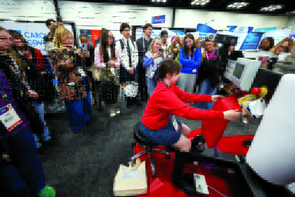 During Advanced Textiles Expo equipment demonstrations on the show floor, textiles students from nearby colleges were encouraged to try their hand at operating the machines.