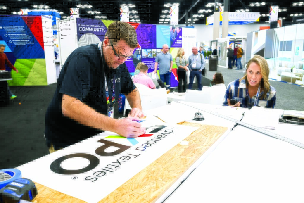 Justin Jones of SewLong Custom Covers competes in a timed event during the Textiles Challenge at Advanced Textiles Expo. 