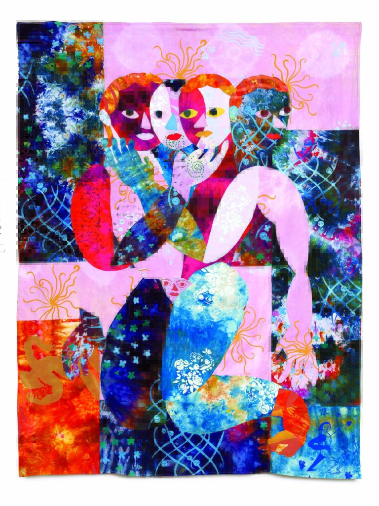 A vibrant quilt with abstract figures in shades of pink, blue, and orange, featuring intricate patterns and layered textures.